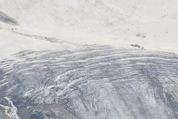 A glacier covered with cracks on the slopes of Elbrus on a summer day