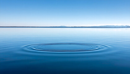 Serene water ripples on tranquil lake surface with distant shoreline and peaceful nature landscape