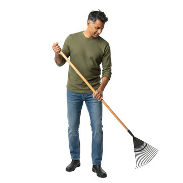 South Asian man raking leaves, enjoying yard work and outdoor chores, cutout isolated on transparent background