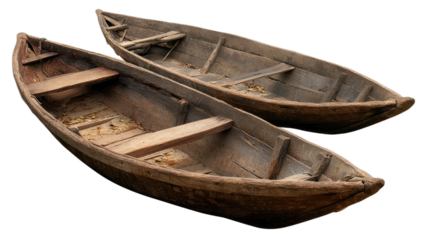 Two old wooden dugout canoes with weathered planks, ready for water
