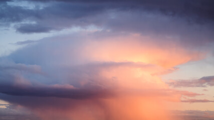 Fototapeta premium Rain streaks from clouds during sunset time