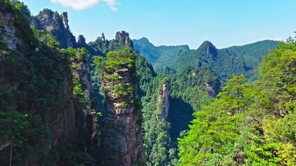 Aerial shot of spectacular sandstone mountain peaks and lush green forest natural landscape in Zhangjiajie, Hunan province, China.