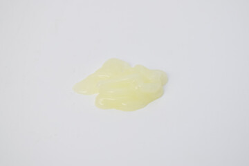 A blob of yellow translucent cosmetic gel texture isolated on a white background. Perfect for beauty, skincare, medical, or hygiene product presentation