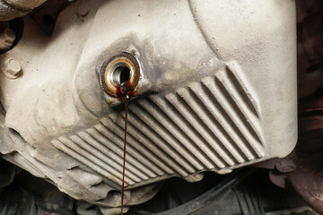 The process of draining used oil from the engine in a car service. Changing the oil in a car....