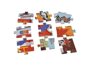 A small pile of cardboard puzzle pieces isolated on a PNG background.