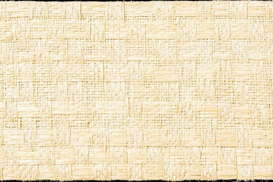 Light-colored woven texture, interlaced strands creating a pattern