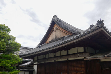 Fototapeta premium Historic wide view of wooden temple building beside forest paths