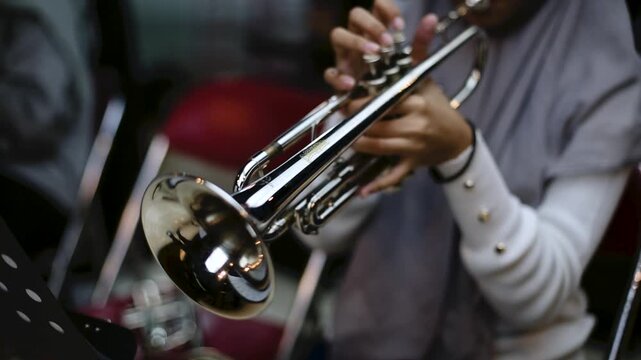Close up hand of Trumpet Player Practicing in a Music Rehearsal Room