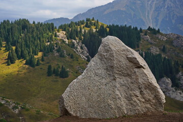 A huge white ak tas stone in the Oi-Karagai mountain gorge.