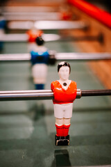 Close-up of a classic red foosball player on table
