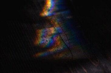 rainbow highlights on dark table boards