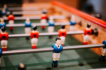 Classic Table Football Game with Blue Player Figure Close-up