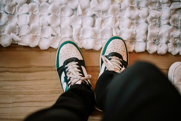 Overhead View of Modern Sneakers on a Path of White Petals