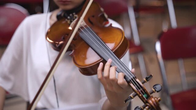 Cinematic Close-Up of Violin Held by Musician During Rehearsal