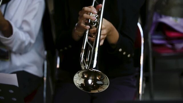 Close up hand of Trumpet Player Practicing in a Music Rehearsal Room