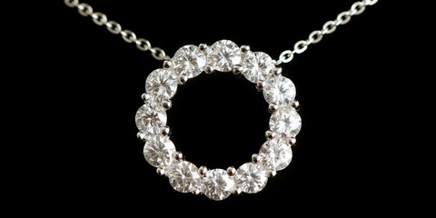 Diamond pendant necklace featuring a brilliant circle of diamonds on a delicate silver chain, presented on a dark background
