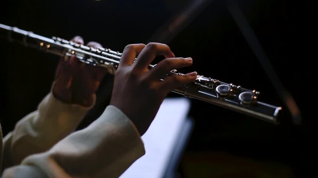 Cinematic Close Up of Musician Playing Silver Flute in rehearsal studio music