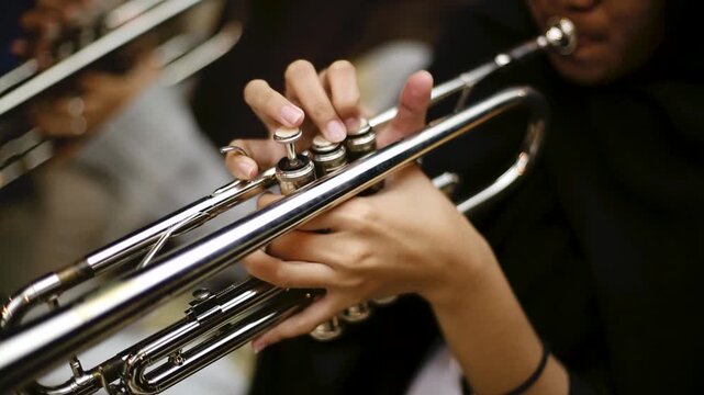 Close up hand of Trumpet Player Practicing in a Music Rehearsal Room