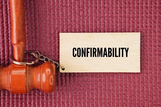 Judge's gavel and wooden tag with the word confirmability. key pillar of trustworthiness in qualitative research that ensures findings are based on participants' data rather than researcher bias