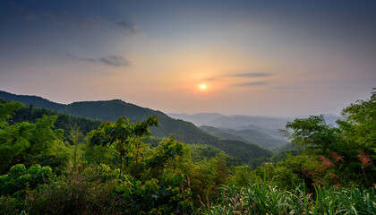 The stunning sight of the sun rising above the mountain