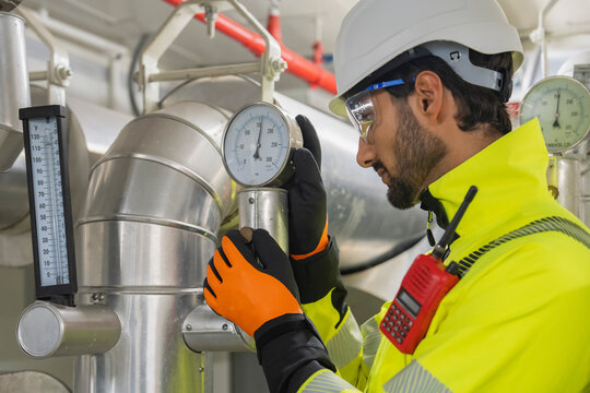 Industrial Cooling System Inspection Civil engineer manager and foreman worker conducting a thorough inspection of the building's industrial air conditioning and water cooling tower