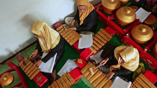 Indonesian women playing traditional javanese gamelan orchestra