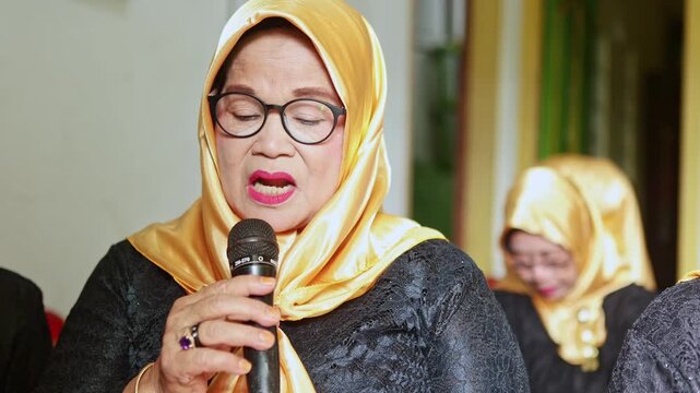 Elderly javanese woman singing traditional gamelan music