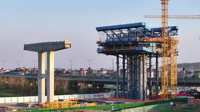 Bridge construction site with crane and piers during girder erection work