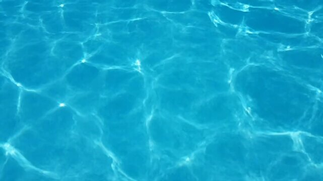 Calming blue water surface with shimmering sunlight reflections
