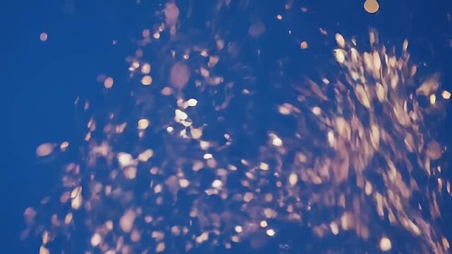 Golden Fire Sparks and Embers Floating on Blue Background
