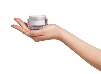 Woman's hand presenting an open, transparent cosmetic cream jar, showcasing a white beauty product in a simple studio setting for skincare and wellness concepts