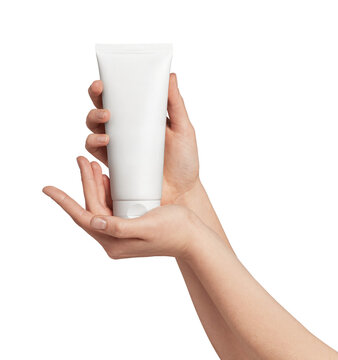 Woman hands presenting an unbranded white cosmetic tube against a clean gray background, minimalist skincare and beauty mockup for product promotion, branding, and advertising uses
