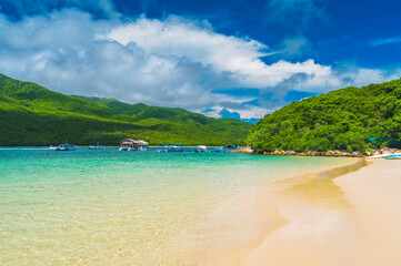 beautiful landscape with white sandy beach in a blue lagoon of the sea on a tropical paradise island in Asian resort in summer