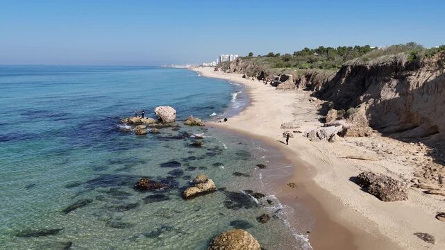Aerial Drone Forward Flight Over Blue Sea Toward Sandy Beach and Cliffs