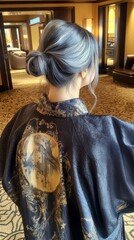 Elegant East Asian Woman with Chic Dark Hair Bun in Stylish Interior Setting