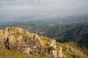 Fototapeta premium High-altitude alpine vegetation and granite rocks in the mountains of Kazakhstan. Scenic summer view of Malaya Almatinskaya Krugosvetka trekking route.