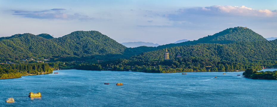 Aerial view of the scenic West Lake with green mountains and traditional pagodas in Hangzhou, China.