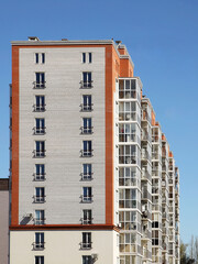 Lviv, Ukraine - 3 4 2020: Facade of a tall multi-storey modern house with balconies and large glass windows. Design of modern architecture. Top view from the bottom. Modern city architecture