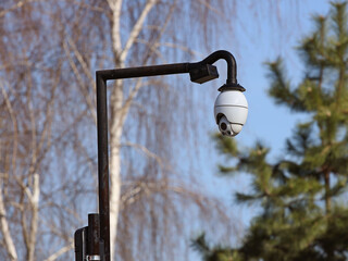 The surveillance system is located on a pole in the open. Threat to confidentiality and protection of personal data. Security tracking on the city streets. Personal privacy and social management