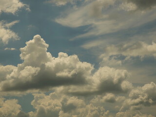 Clear blue sky with cumulus and cirrus clouds. Sunny weather. Joyful mood. High pressure. Clean air ecology. Water in a gaseous state. The source of rain and hail. Weather prediction