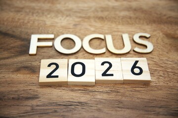 Fototapeta premium Focus 2026 message built from wooden letters on wood material background. Future planning, personal goals, productivity mindset and calendar date strategy concepts.