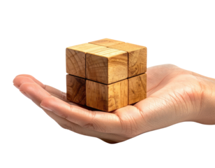 Hand cradles wooden puzzle cube against a black backdrop