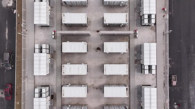 Industrial park with energy storage battery arrays and factory buildings in a panoramic view