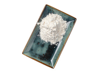 Powdered white flour mound on a rustic blue ceramic tray with chipped edges