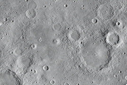 Detailed view of a cratered planetary surface with varied terrain and impact scars
