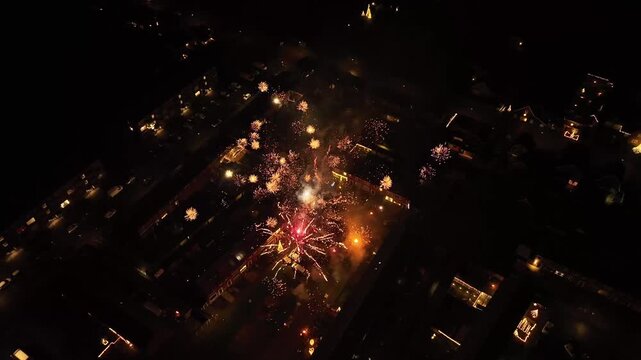 Aerial footage of lots of fireworks going into the sky at new years eve