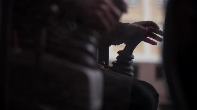 Excavator operator controlling hydraulic joystick inside cabin