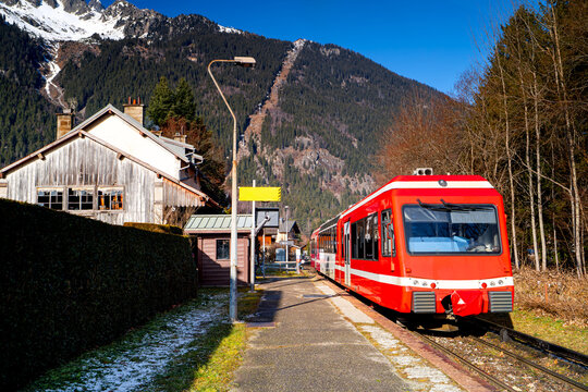 Red train at Les Praz de Chamonix station. French Railway in the Alps.
