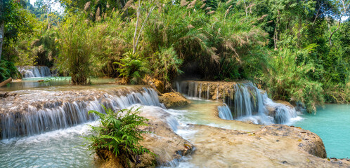 Multi-tiered waterfalls and turquoise natural pools in Kuang Si Falls (or Tat Kuang Si), Kuang Si...