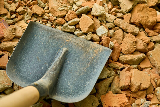 Construction cleaning.Scoop shovel on garbage collection,repair - Powered by Adobe